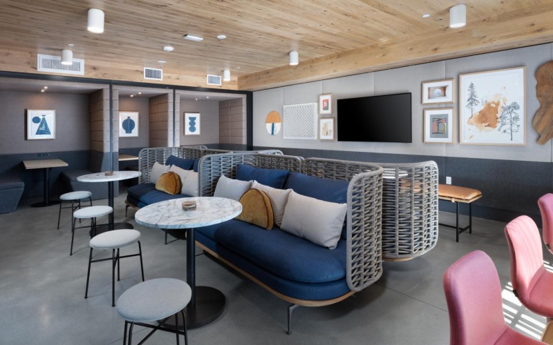 a room with a couch and chairs