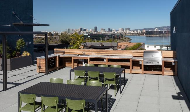 Settle into comfort at Star Harbor a patio with tables and chairs overlooking a city