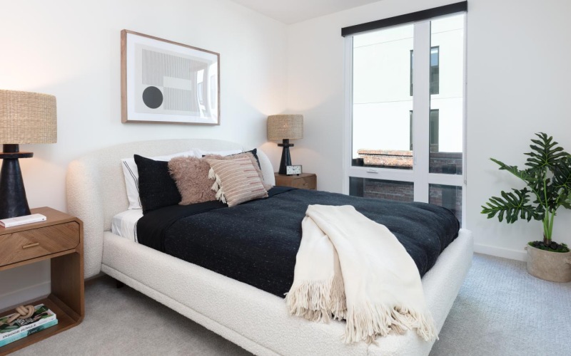 a bedroom with a bed and lamps